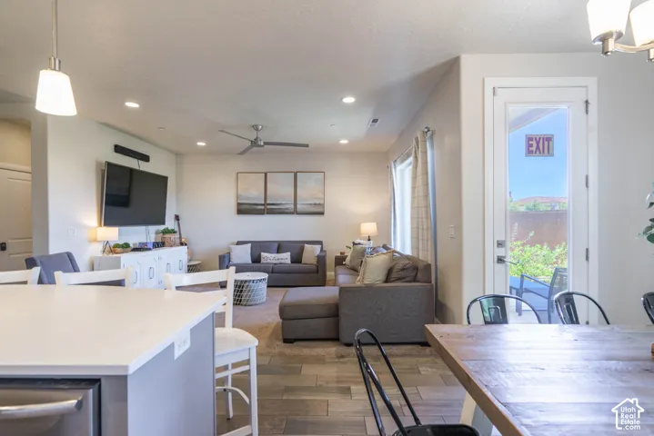 Open-concept interior featuring tile flooring, neutral wall tones, recessed lighting, ceiling fan, and a glass-paneled exterior door