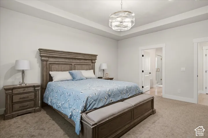 Primary suite is conveniently located on main level and features a tray ceiling, designer lighting and a huge walk in closet