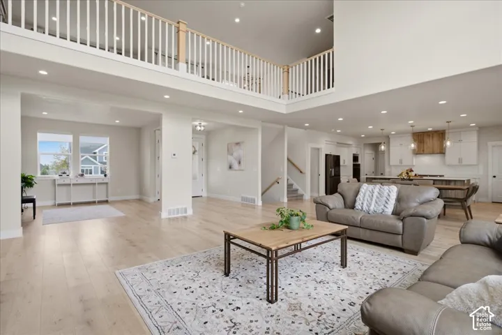 Designer lighting and beautiful LVP flooring complement the open layout