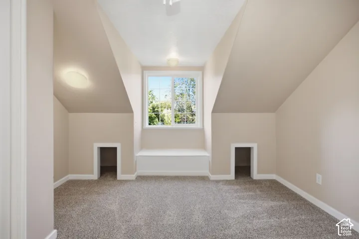 Vaulted ceiling, built-in window seat, dual recessed nooks, and wall-to-wall carpeting