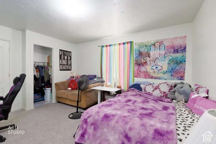 Room featuring neutral wall finishes, carpeting, and a reach-in closet