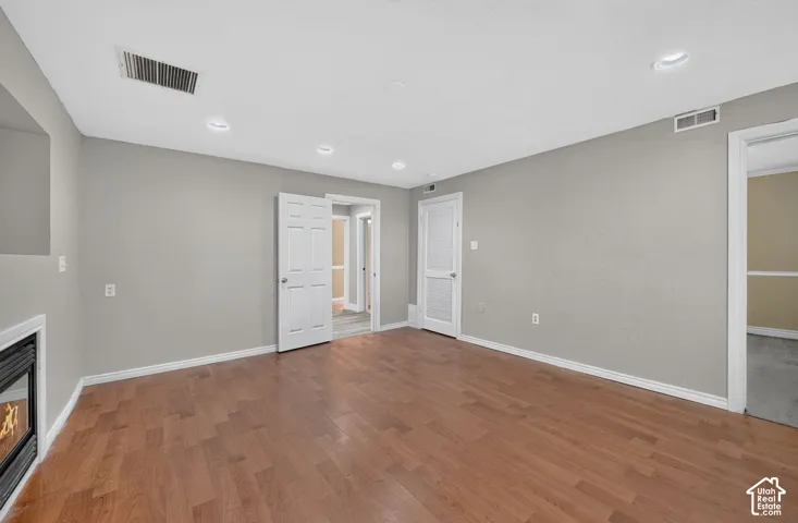 Interior space featuring wood-finish flooring, recessed lighting, and a wall-mounted fireplace