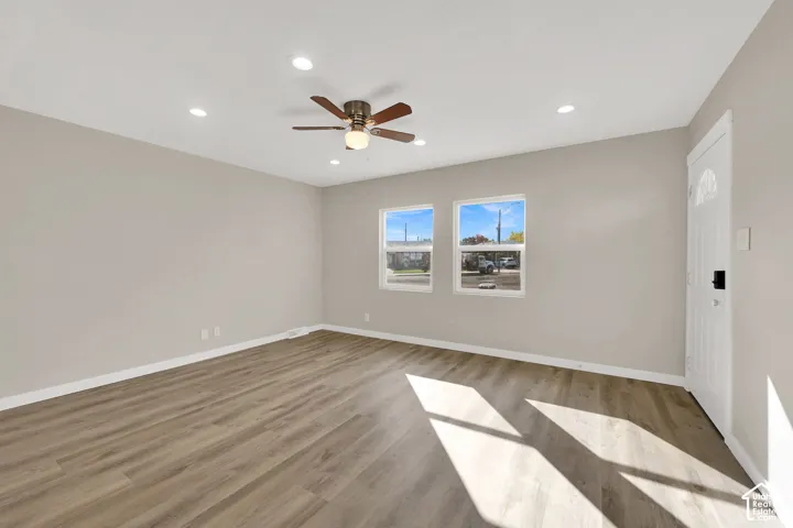 Interior space featuring wood-finish flooring, recessed lighting, a central ceiling fan, and double-pane windows