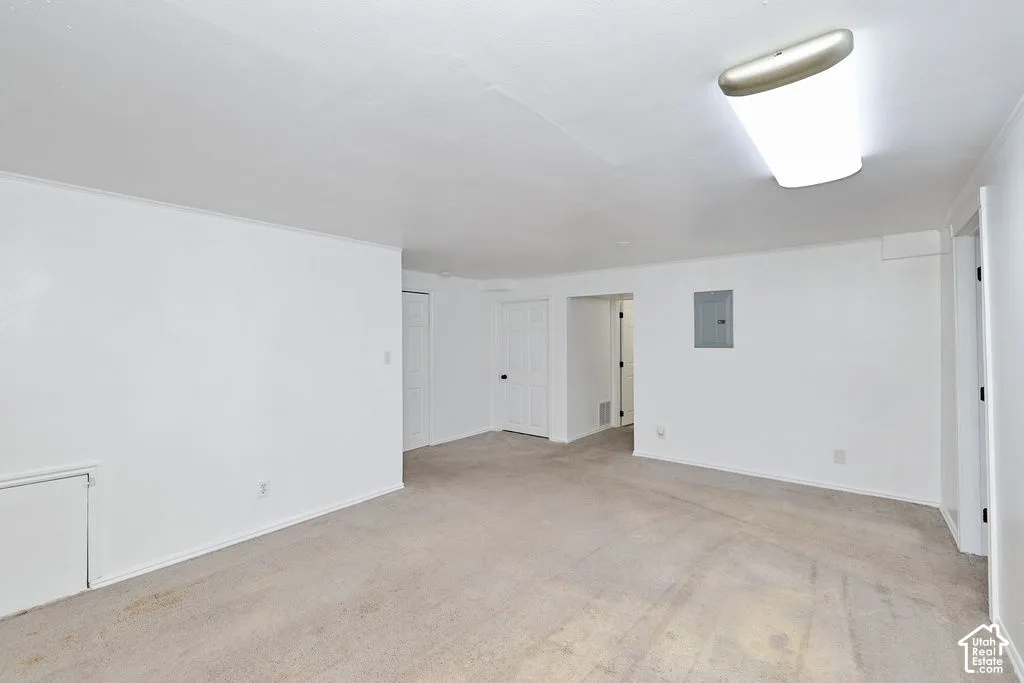 Neutral-toned carpeting, white-painted walls, and ceiling-mounted flush lighting