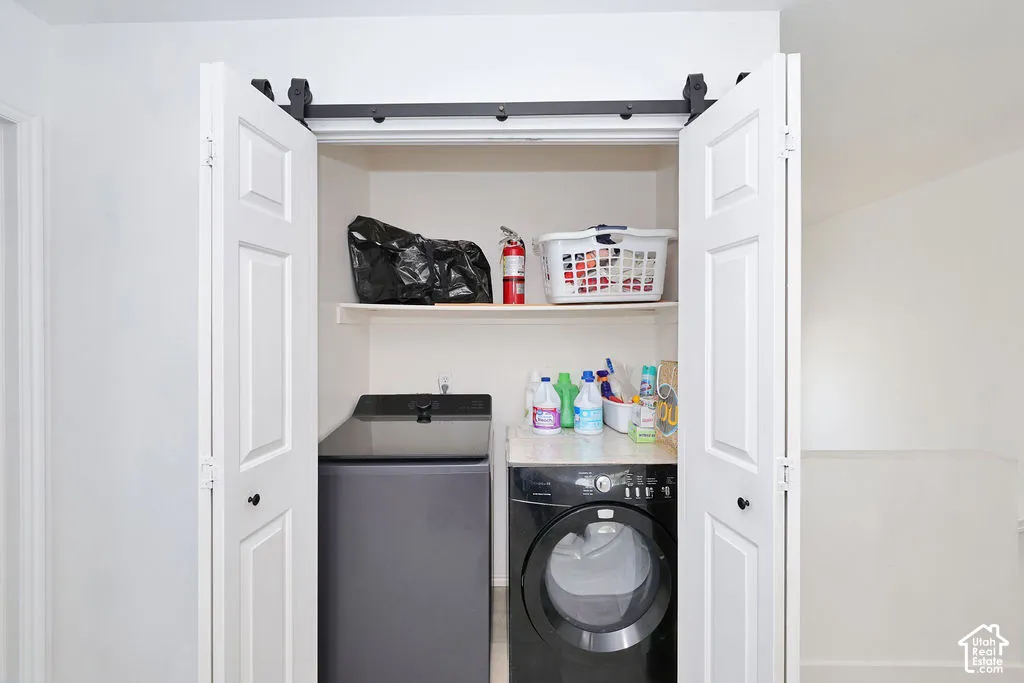 Bi-fold closet doors featuring a matte black sliding track hardware system, built-in upper shelf, and stone-finish countertop surface