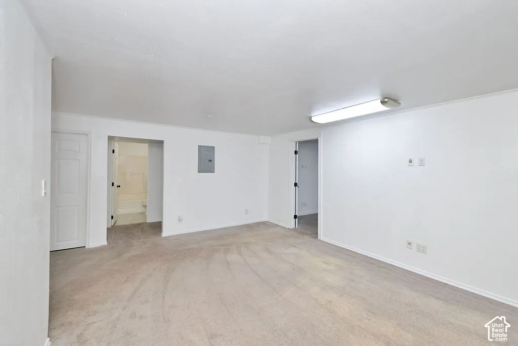 Neutral-toned wall-to-wall carpeting, flush-mount lighting, and solid-core interior doors