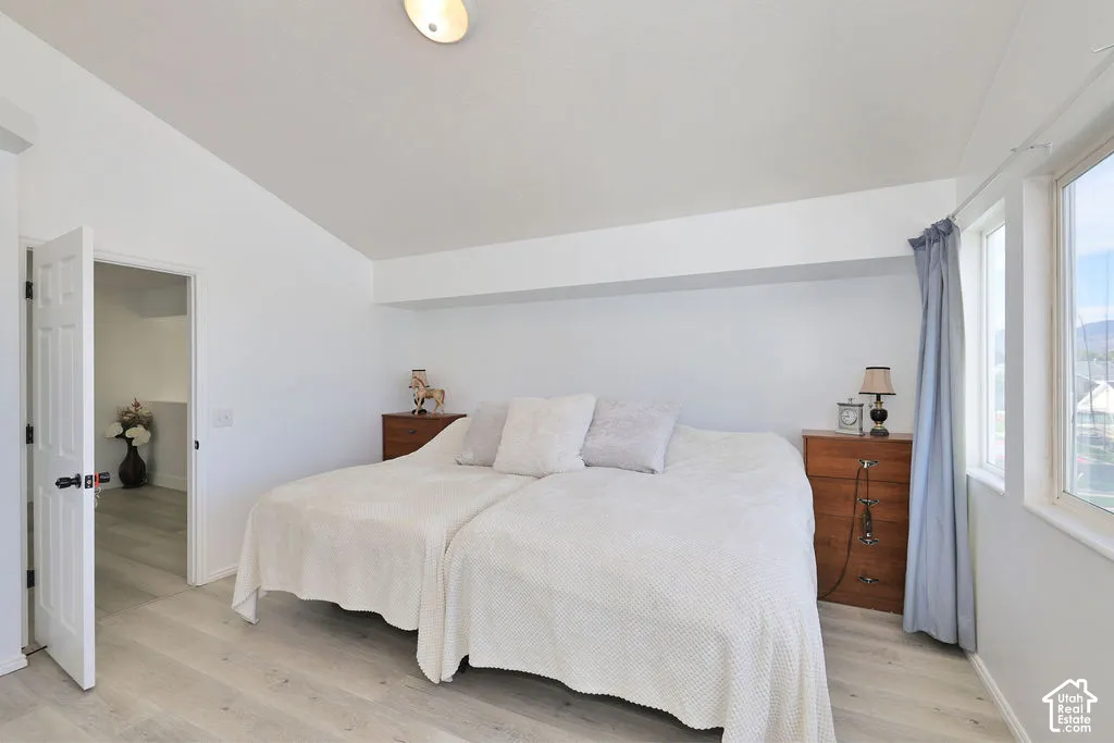 Vaulted ceilings, wood-finish flooring, and natural light from large windows