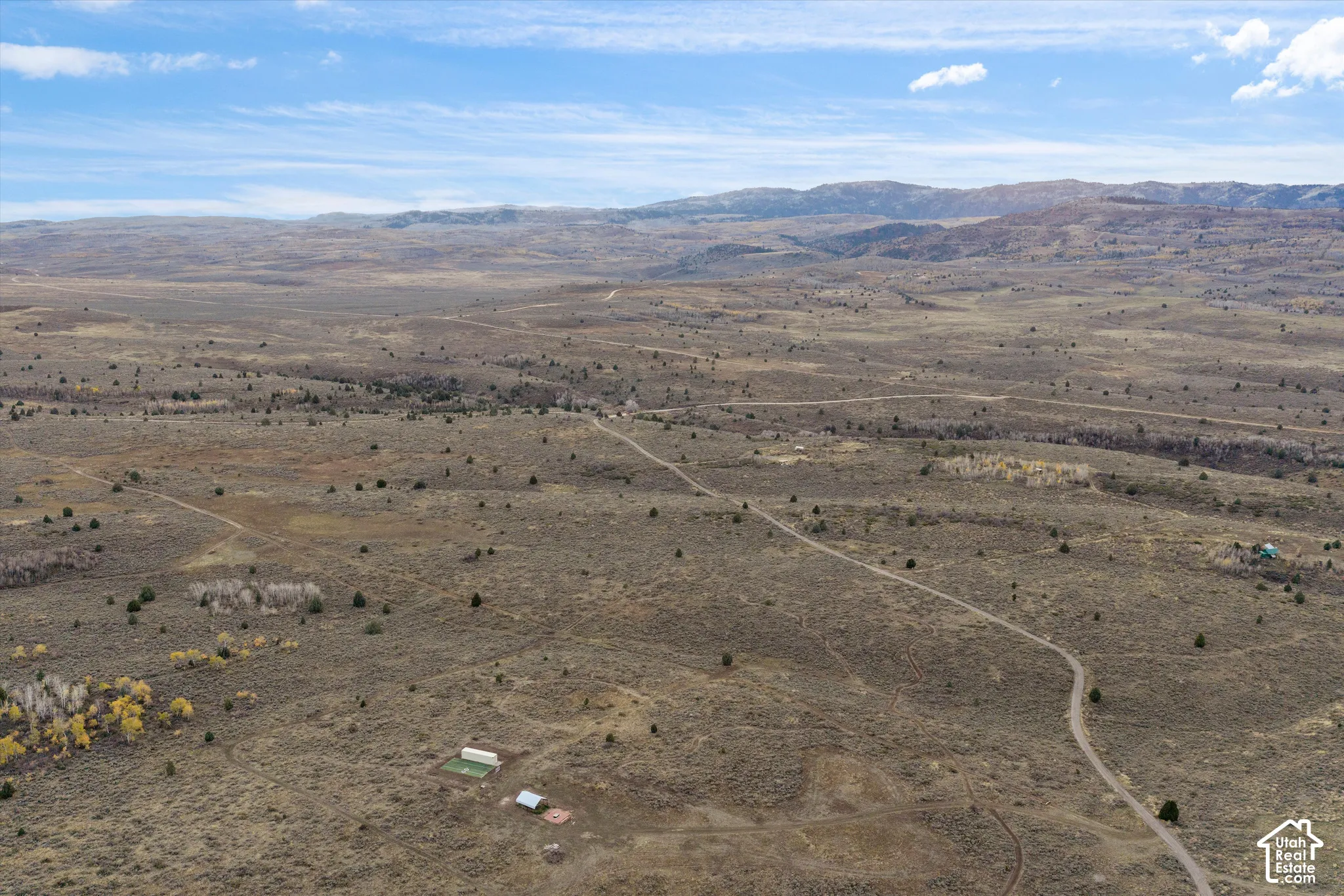 Expansive acreage featuring rugged terrain, mountain topography, and dirt access roads