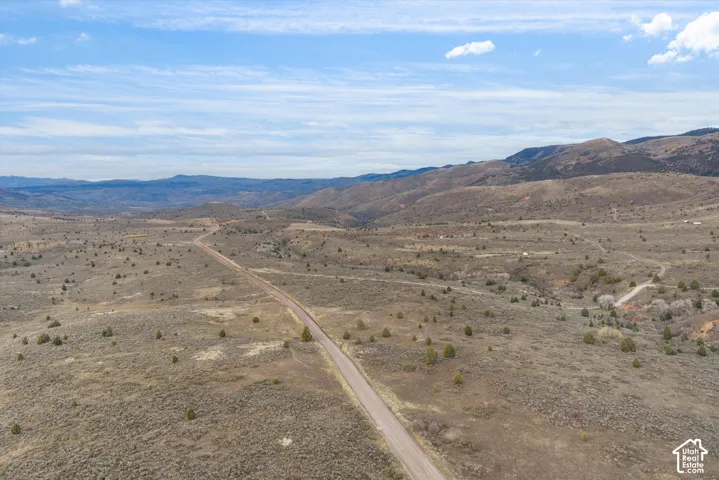 Expansive desert acreage featuring native scrub brush, rolling topography, and unobstructed mountain horizons