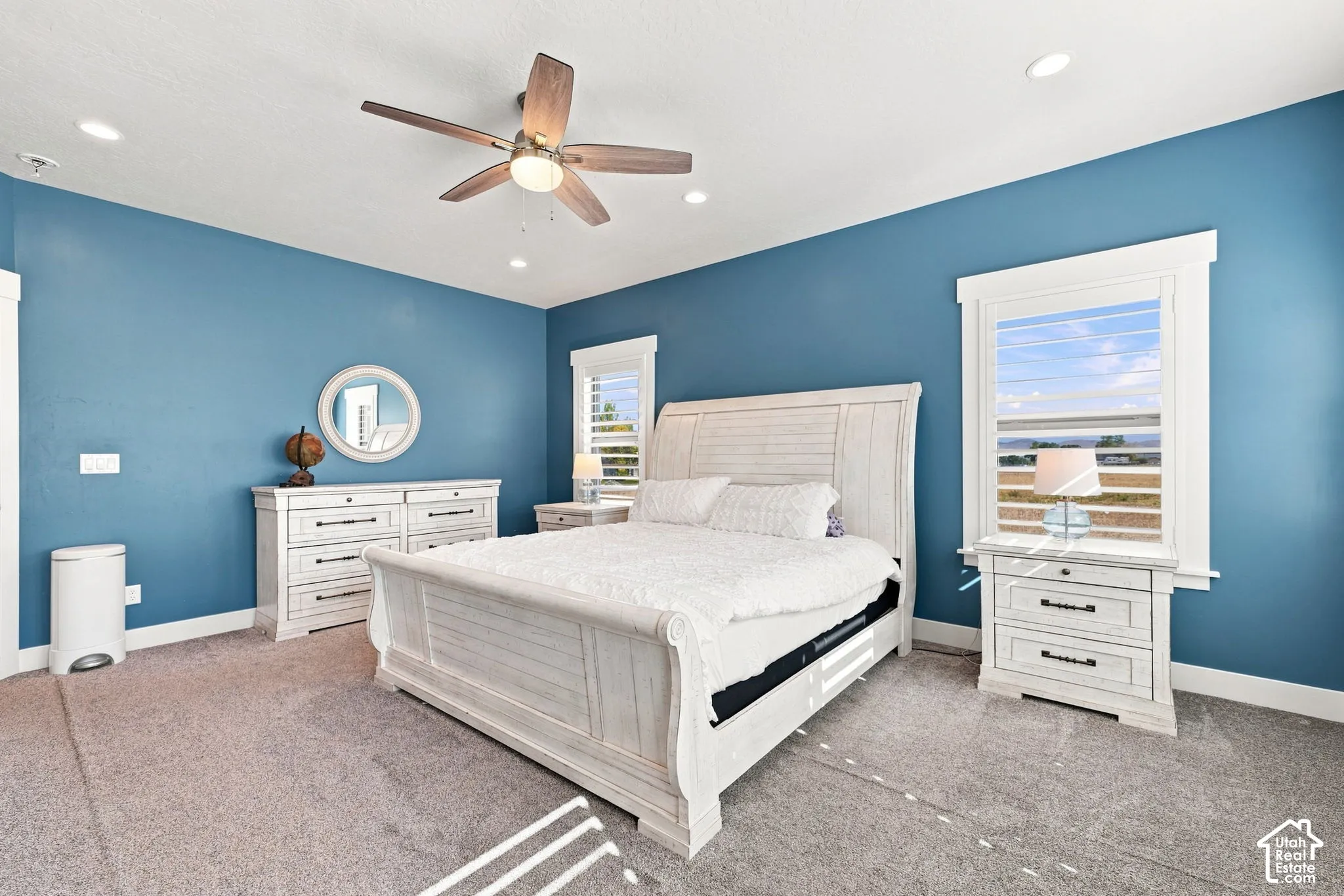Bedroom featuring recessed lighting, a ceiling fan with integrated light, thick window trim, and plantation shutters