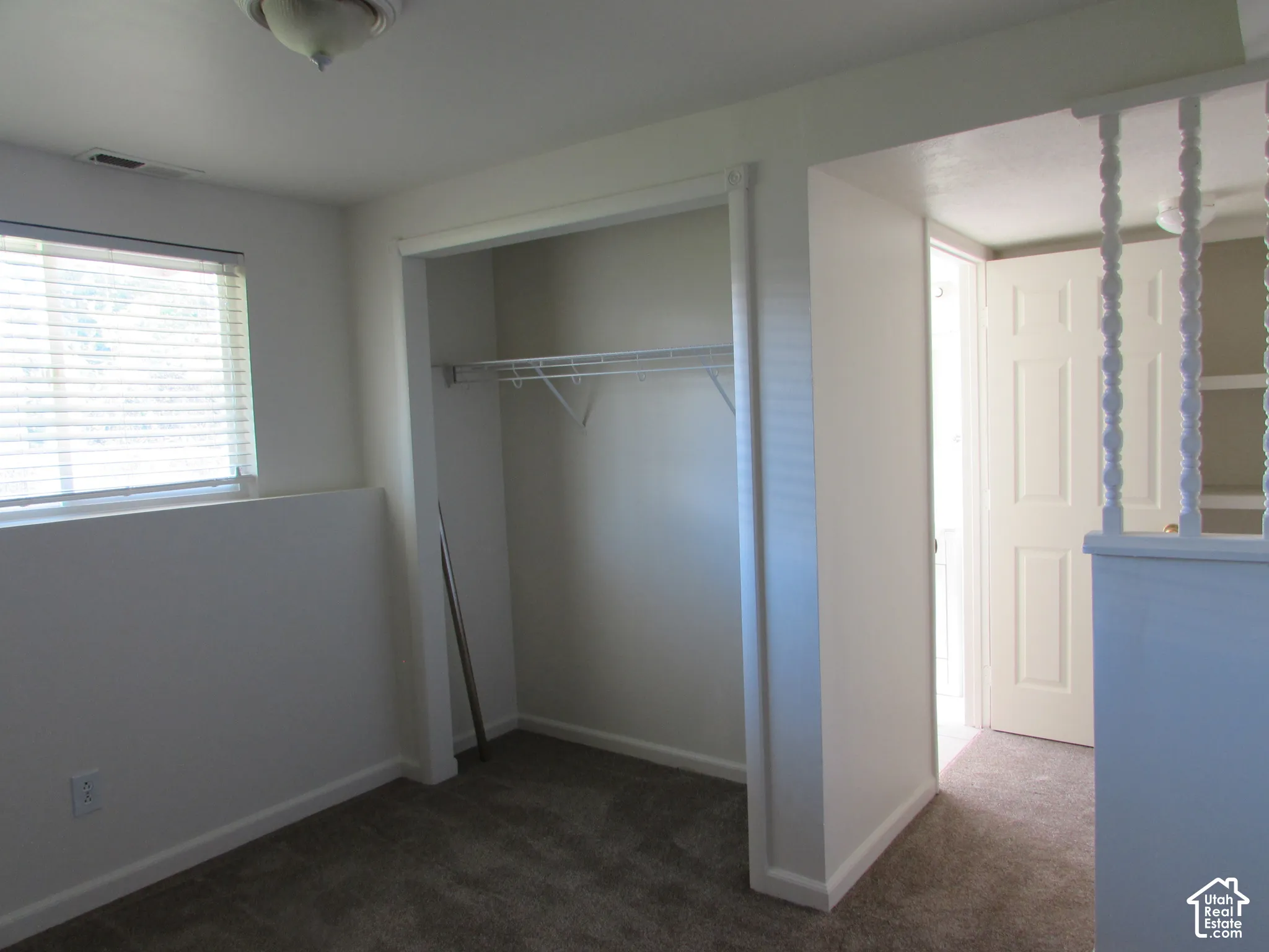 Wall-to-wall carpeting with built-in closet featuring wire shelving