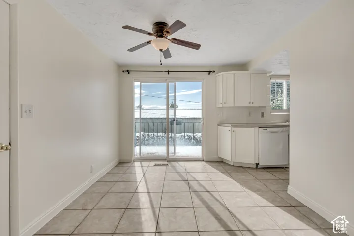 Dining area featuring tile flooring, a ceiling fan, and a sliding glass door