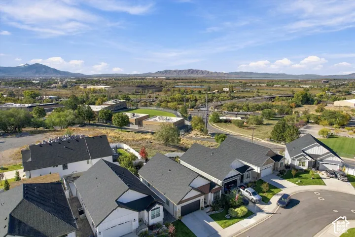 Aerial perspective featuring residential lots with cul-de-sac access, multi-pitch shingle roofing, and expansive mountain range scenery