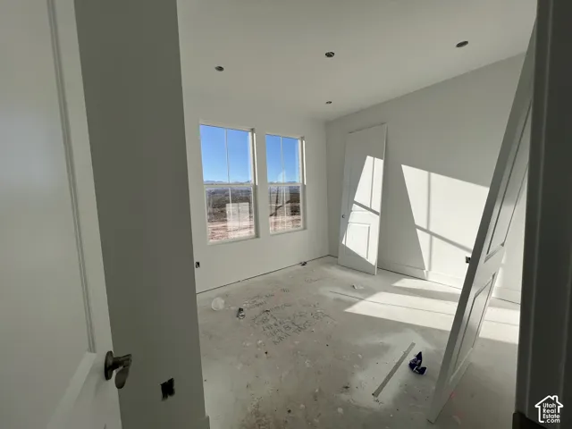Interior space featuring recessed lighting, dual windows with mountain scenery, and paneled doors