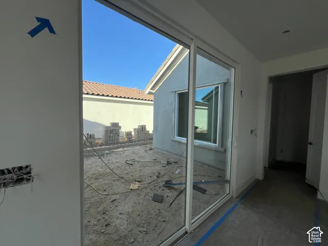 Large sliding glass door with white frame and neutral interior walls