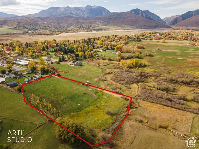 Expansive parcel featuring open acreage, natural vegetation, and mountain backdrop