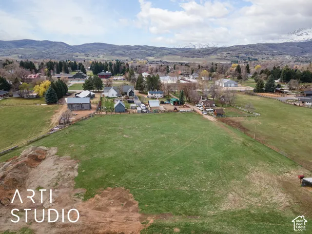 Expansive acreage featuring open pasture, perimeter fencing, and mountain topography
