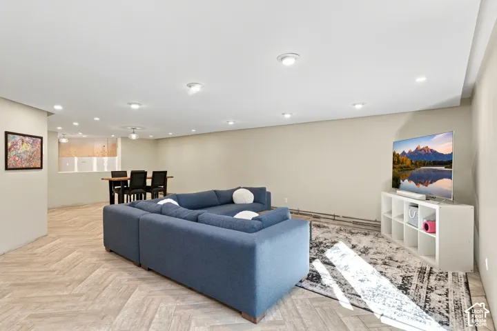 Open floor plan featuring recessed lighting and herringbone-pattern wood-finish flooring