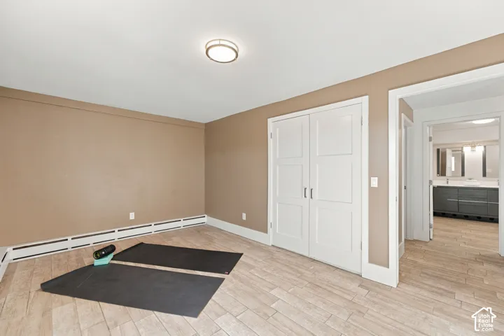 Wood-finish flooring, double-panel interior closet doors, and flush-mount ceiling lighting