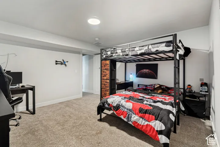 Recessed ceiling lighting, light gray wall paint, and gray carpeting