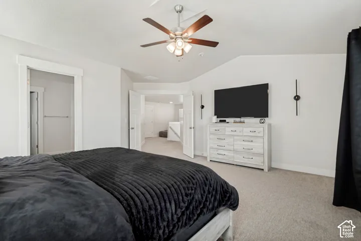Carpeted room featuring a ceiling fan, white walls, and a built-in entertainment niche