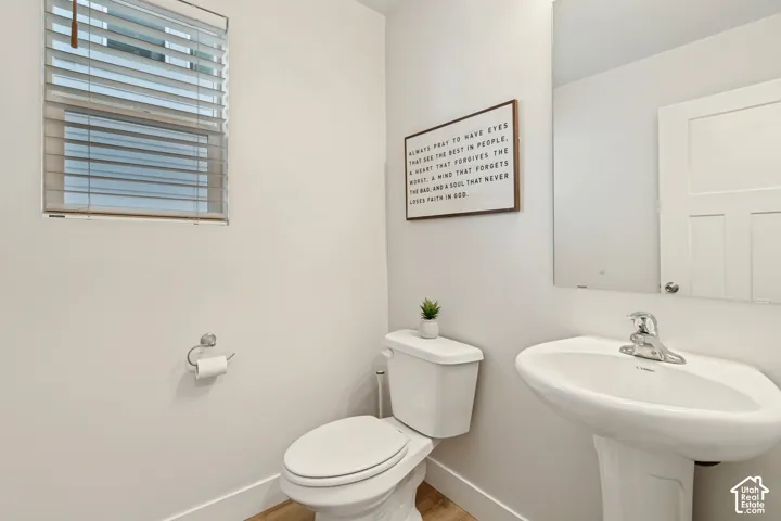 White pedestal sink with chrome faucet