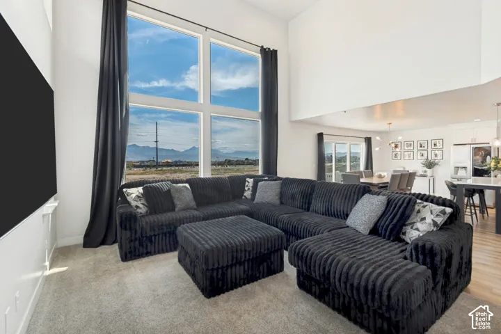 Two-story great room with expansive windows, providing abundant natural light