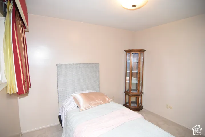 Bedroom #2 Neutral interior walls, wall-to-wall carpeting, and a flush-mount overhead ceiling light fixture