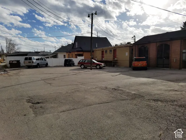 Paved surface parking area featuring brick masonry construction and arched exterior entryways