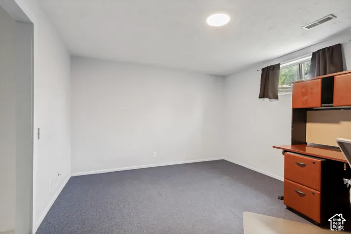 Interior room featuring carpeting, a horizontal sliding window, and neutral wall paint