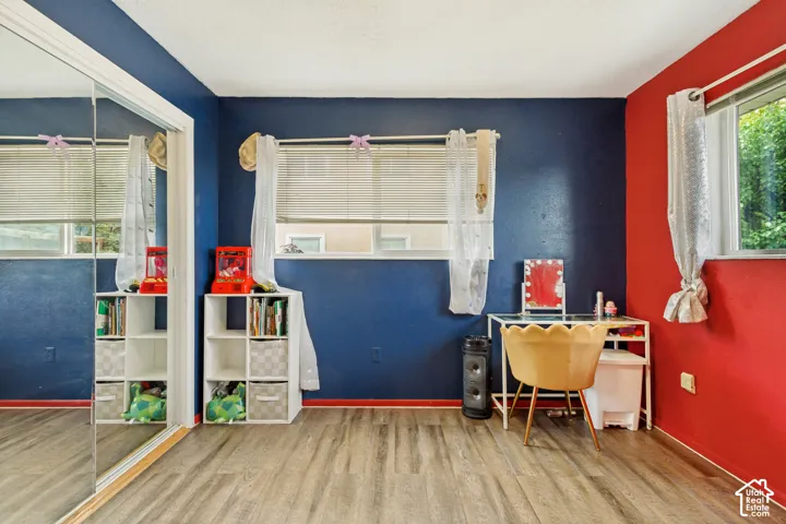 Wood-finish flooring, full-wall mirrored sliding closet doors, and dual-pane windows