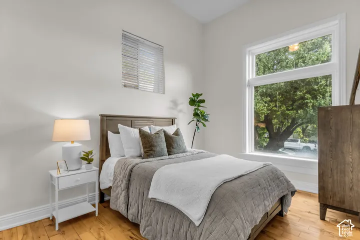 Light-filled interior featuring wood-finish flooring, a large picture window, and neutral wall tones