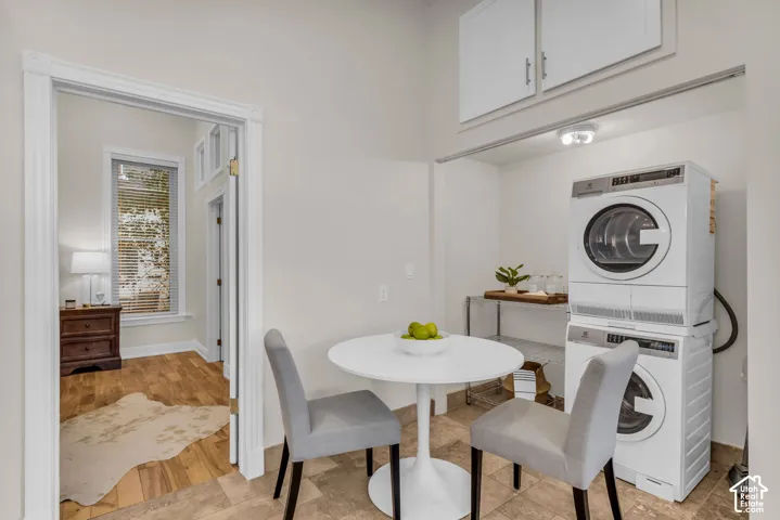 Utility area featuring tile flooring, ceiling-mounted lighting, and built-in upper cabinetry