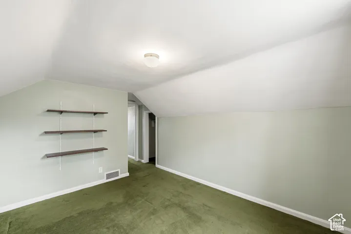 Vaulted ceiling with attached dome lighting and three wall-mounted shelving units