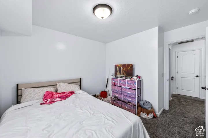 Neutral-toned carpeting, crisp white walls, and a recessed dome-style ceiling light fixture