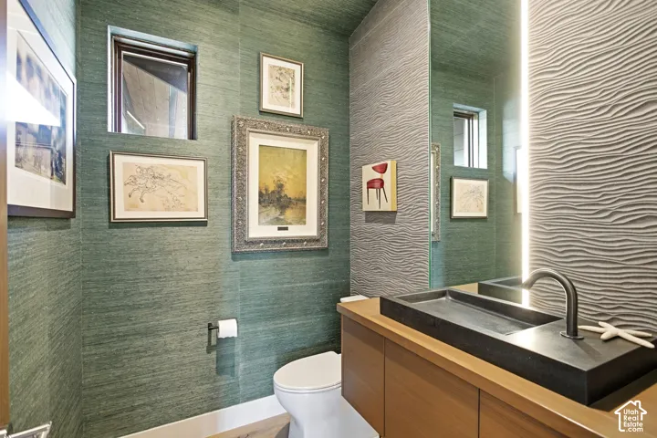 Textured wallcoverings, floating vanity with a dark rectangular vessel sink, matte black faucet, and vertical LED-accented wall with wave-patterned tile finish