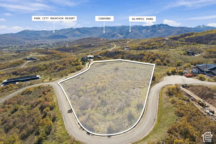 Expansive corner lot with mountain scenery and paved road access
