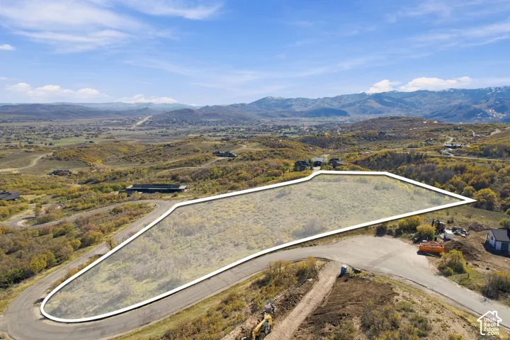 Expansive corner lot with paved road access and mountain backdrops