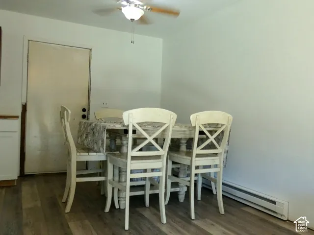 Room featuring wood-finish flooring and a central ceiling fan with integrated lighting
