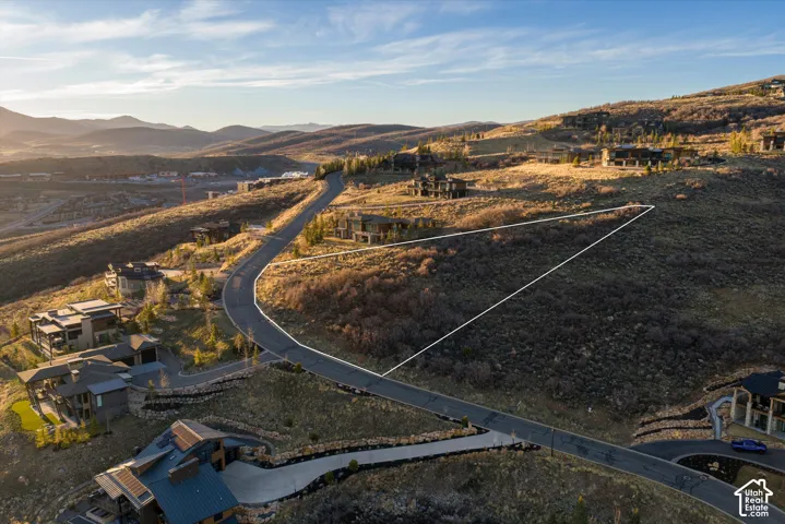 Expansive parcel of sloped land featuring mountain topography, native vegetation, and paved street access