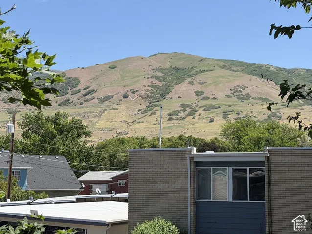 Exterior featuring brick masonry, paneled siding, and expansive mountain scenery
