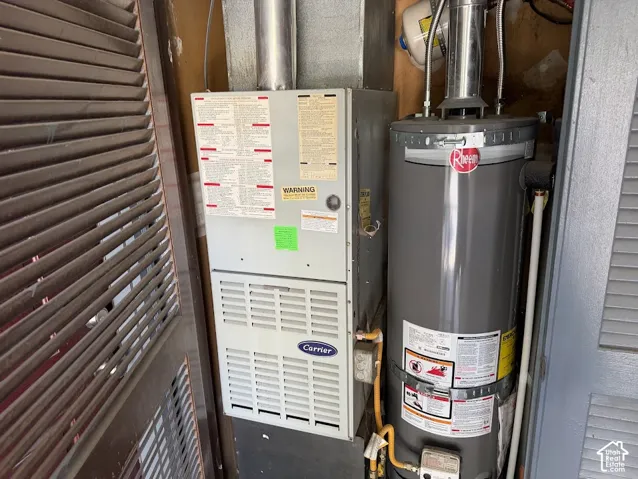 Carrier forced-air furnace and Rheem water heater housed within a louvered utility closet