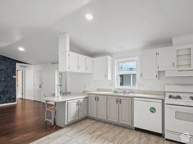 Kitchen featuring white upper cabinetry, grey lower cabinetry, integrated peninsula, recessed lighting, and tile flooring