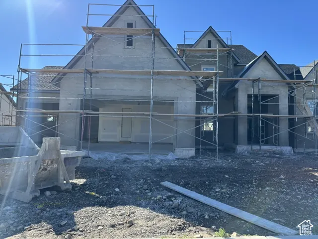 Multi-gabled exterior facade featuring a multi-level roofline, prominent peaked roof peaks, and exterior framing