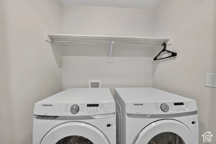 Laundry area featuring a built-in shelf and hanging rod