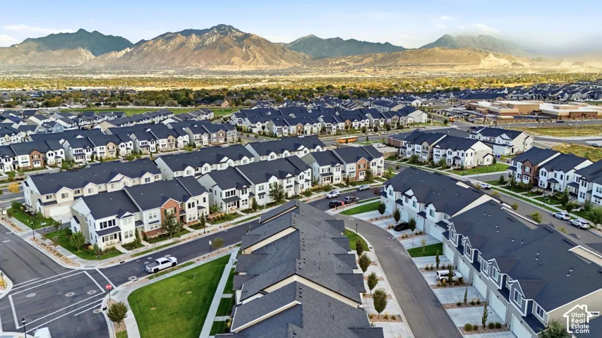 Mountain backdrop, residential community, tree-lined streets, paved roads, and multiple housing styles