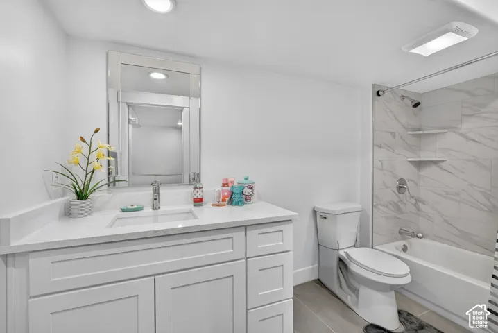 White shaker-style vanity with a single basin sink and light-toned countertop