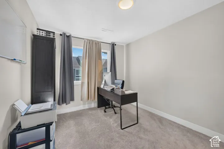 Neutral wall paint, carpeted flooring, and a flush-mount ceiling light