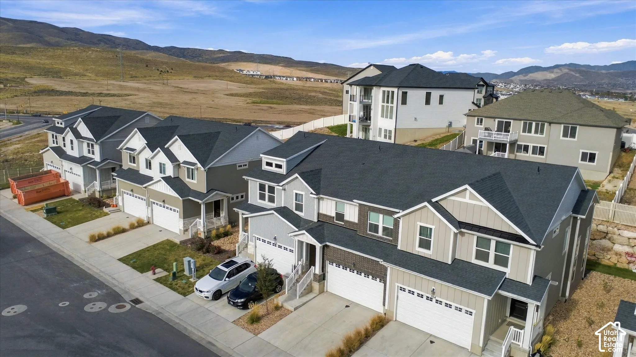 Multi-story residential exteriors featuring composite shingle roofing, dual-tone siding, attached two-car garages, and concrete driveways