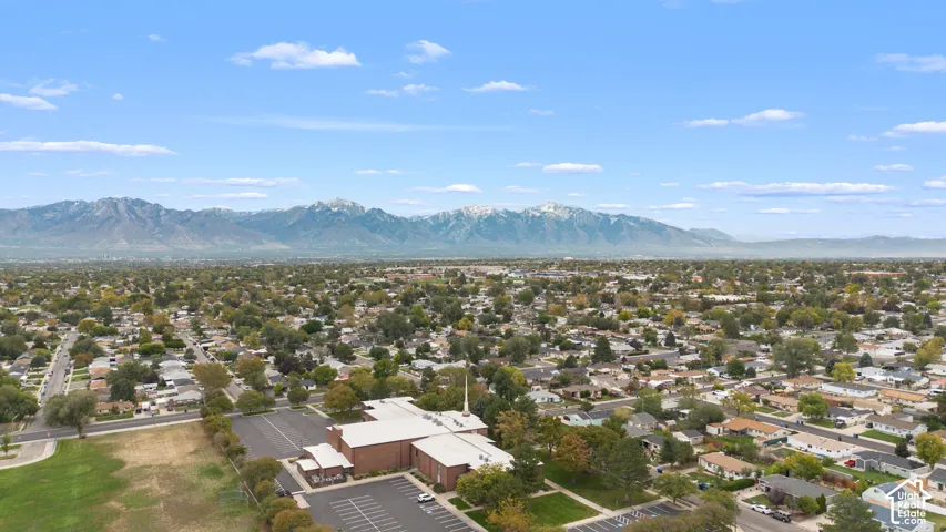 Aerial perspective showcasing an expansive mountain backdrop and established residential neighborhood grid